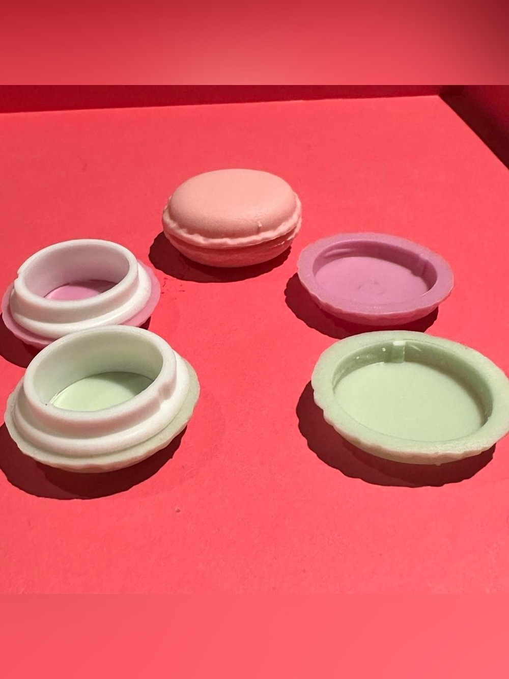 3 pink green and purple macron jewelry ring boxes.